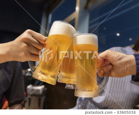 People toasting mug draft beer at a restaurant People toasting mug draft beer at a restaurant 83605038
