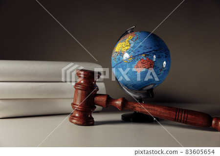Wooden gavel and globe on the desk. International law and justice court concept Wooden gavel and globe on the desk. International law and justice court concept 83605654