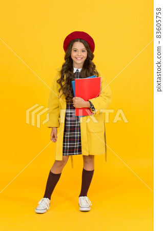 cheerful small girl in school uniform with notebooks, learning 83605758