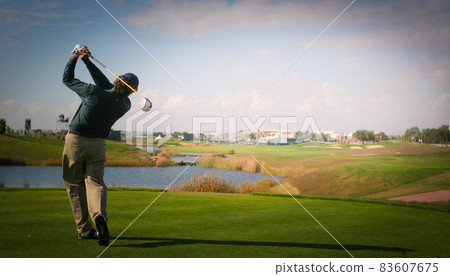 man golfer on a golf course man golfer on a golf course 83607675