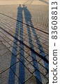Shadow of men on the floor in the evening. 83608813