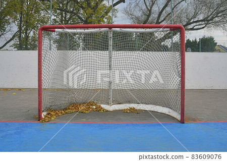 Abandoned hockey goal in fall. Concept of finished field hockey season Abandoned hockey goal in fall. Concept of finished field hockey season 83609076