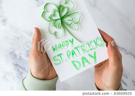 Gift idea, decor Spring, happy Patrick Day. Step by step. Diy St. Patricks Day greeting card made of Quilling and paper clovers on white background. 83609920