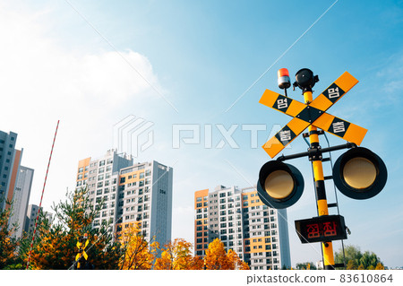 Hangdong Railroad crossing signal railroad barrier at autumn in Seoul, Korea 83610864
