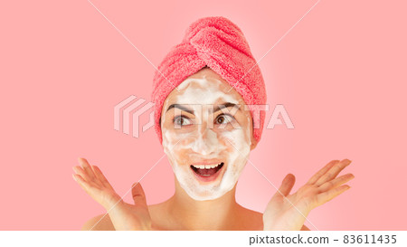Happy woman applying foam for wash face, skincare concept 83611435