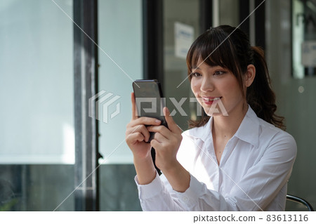 Close up woman use of smart phone, charming asian girl video call via mobile phone 83613116