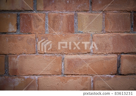 Grey white black red orange old vintage brick wall background. Rustic cemented dark brick house wall texture with grunge surface. Shabby Building Facade With Damaged Plaster. Aged weathered exterior 83613231