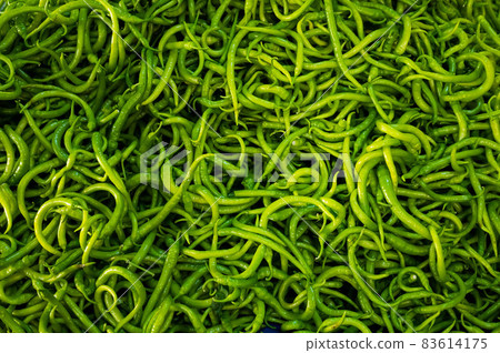 Close-up on a shelf with green peppers in the market. 83614175