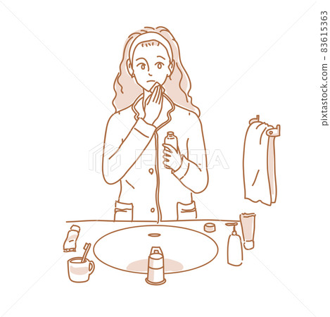 A woman doing skin care in her pajamas A woman doing skin care in her pajamas 83615363