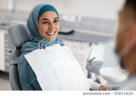 Smiling Muslim Lady In Hijab Having Check Up In Modern Dental Clinic Smiling Muslim Lady In Hijab Having Check Up In Modern Dental Clinic 83615820