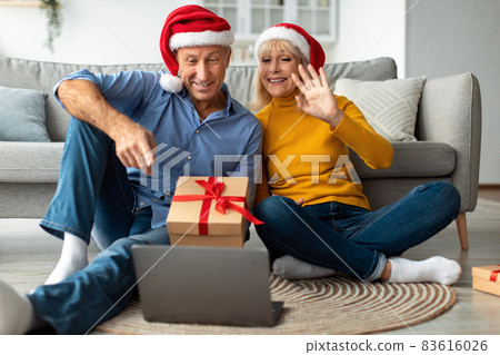 Senior Couple At Laptop Video Calling Celebrating Christmas Distantly Indoor Senior Couple At Laptop Video Calling Celebrating Christmas Distantly Indoor 83616026
