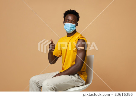 Vaccination Advertisement. Vaccinated Black Guy With Plaster On Arm Showing Thumb Up 83616396