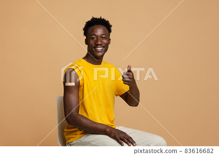 Vaccination Concept. Happy Vaccinated Black Guy Showing Thumb Up At Camera Vaccination Concept. Happy Vaccinated Black Guy Showing Thumb Up At Camera 83616682