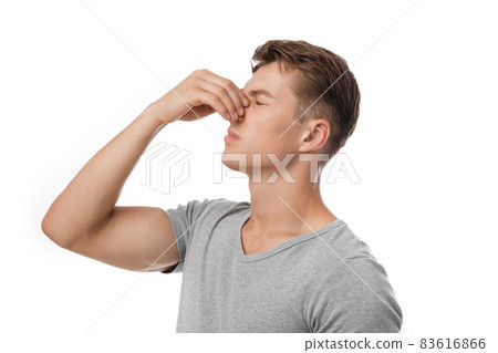 Sad millennial caucasian attractive guy presses hand to nose, suffers from pain after injury, bleeding and headache Sad millennial caucasian attractive guy presses hand to nose, suffers from pain after injury, bleeding and headache 83616866