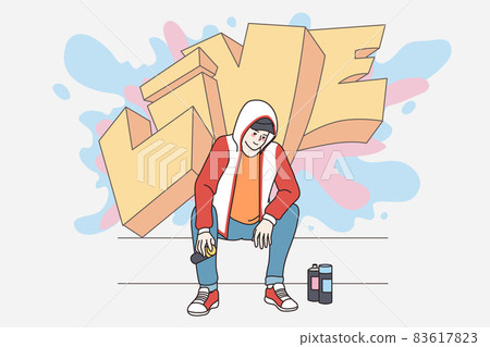Happy millennial man drawing graffiti on street wall  83617823
