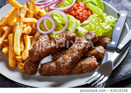 cevapcici with potato fries, lettuce, onion, ajvar cevapcici with potato fries, lettuce, onion, ajvar 83618106