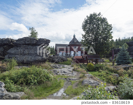 Old rustic building of Topferbaude viewpoint restaurant and hut next to hill Topfer near the town of Oybin at Zittauer Gebirge mountains nature park in Saxony, germany. Summer sunny day Old rustic building of Topferbaude viewpoint restaurant and hut next to hill Topfer near the town of Oybin at Zittauer Gebirge mountains nature park in Saxony, germany. Summer sunny day 83618619