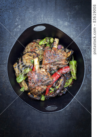 Traditional barbecue leg of lamb with eggplant and chili  83619008