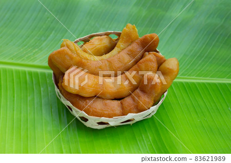 Tamarind pickled fermented in bamboo basket on banana leaf 83621989