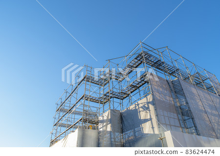 Building construction site Building under construction, scaffolding and curing curtain a-2 Low contrast Building construction site Building under construction, scaffolding and curing curtain a-2 Low contrast 83624474