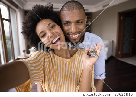 Joyful young african american couple showing keys. 83625919