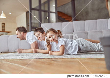 Happy children doing training with father at home Happy children doing training with father at home 83626428