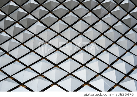 Metallic structure with geometric shapes on a building roof 83626476