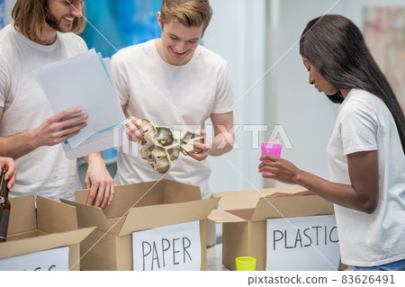 Young ecologists working in a recycling center Young ecologists working in a recycling center 83626491