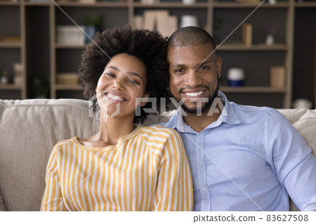 Portrait of happy relaxed young african american family couple. 83627508