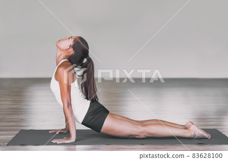 Asian woman stretching lower back with yoga cobra pose on exercise mat. Upward facing dog backbend pose yoga girl. Urdhva mukha svanasana exercise Yoga stretch practice for weight loss. Asian woman stretching lower back with yoga cobra pose on exercise mat. Upward facing dog backbend pose yoga girl. Urdhva mukha svanasana exercise Yoga stretch practice for weight loss. 83628100