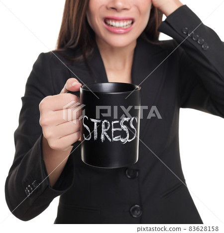 Stressed business woman drinking coffee mug with the word STRESS written on it. Anxiety, panic at work office. Businesswoman on burnout. 83628158