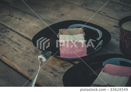 Tricolor ice cream in black plates and on a wooden table. Chocolate, strawberry and vanilla ice cream. Portions of ice cream. Selective focus Tricolor ice cream in black plates and on a wooden table. Chocolate, strawberry and vanilla ice cream. Portions of ice cream. Selective focus 83628549