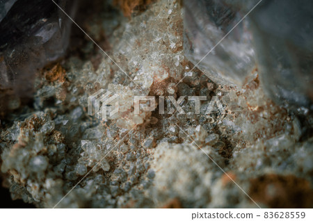 A sample of rock with amethyst under great magnification. Mountain mineral with crystals. Macro, horizontal composition 83628559