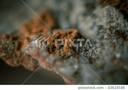 A sample of rock with amethyst under great magnification. Mountain mineral with crystals. Selective focus, blur. Macro, horizontal composition 83628586