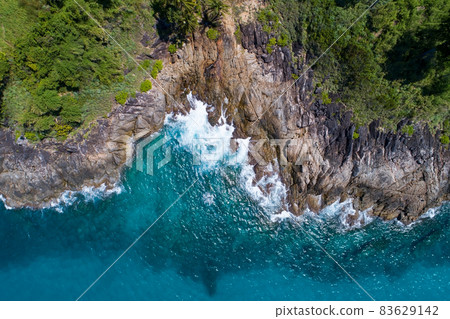 Amazing Aerial view of sea waves hitting rocks with turquoise sea water Beautiful seascape in the Phuket island coastline Thailand Travel and tour concept 83629142