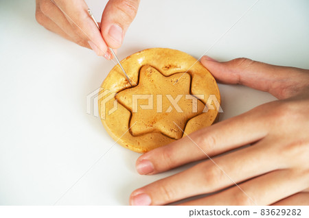 Hands closeup scratch brown sugar caramel candy cookies Hands closeup scratch brown sugar caramel candy cookies 83629282