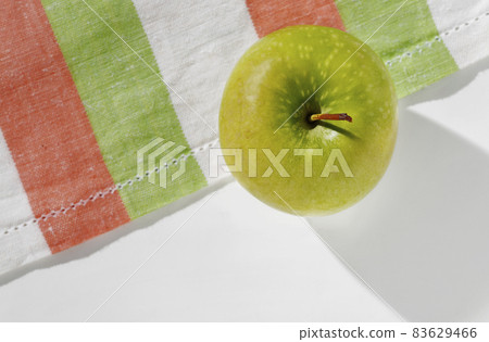 One green apple on table 83629466
