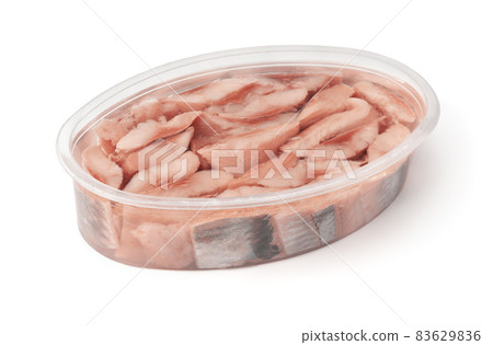 Pieces of pickled herring in plastic container 83629836