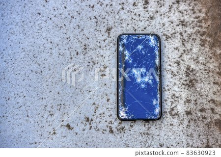A smartphone with a broken screen when dropped A smartphone with a broken screen when dropped 83630923
