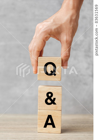 Hand holding Q and A word with wooden block. FAQ( frequency asked questions), Answer, Question  Ask, Information, Communication and Brainstorming Concepts 83631569
