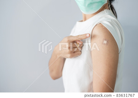 woman showing bandage after receiving covid 19 vaccine. Vaccination, herd immunity, side effect, booster, vaccine passport and Coronavirus pandemic woman showing bandage after receiving covid 19 vaccine. Vaccination, herd immunity, side effect, booster, vaccine passport and Coronavirus pandemic 83631767