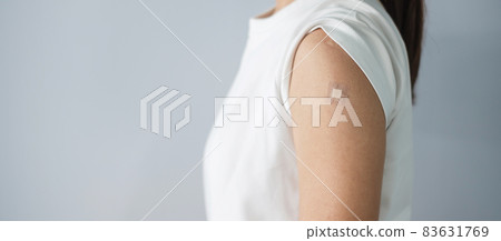 woman showing bandage after receiving covid 19 vaccine. Vaccination, herd immunity, side effect, booster, vaccine passport and Coronavirus pandemic 83631769