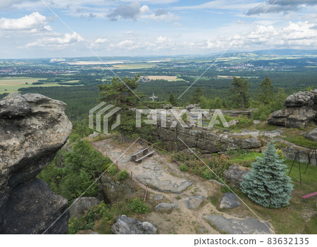 View from hill Topfer sandstone viewpoint near Oybin with view of Zittau town at Poland German borders in Zittauer Gebirge mountains, Saxony, germany. Summer sunny day, blue sky, white clouds View from hill Topfer sandstone viewpoint near Oybin with view of Zittau town at Poland German borders in Zittauer Gebirge mountains, Saxony, germany. Summer sunny day, blue sky, white clouds 83632135