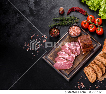 Delicious fresh bacon sliced with bread and vegetables Delicious fresh bacon sliced with bread and vegetables 83632429