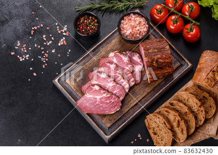 Delicious fresh bacon sliced with bread and vegetables 83632430