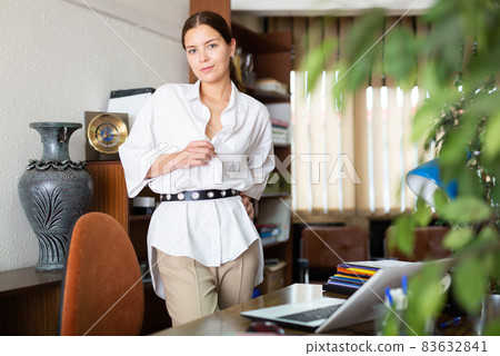 Attractive secretary posing in office 83632841