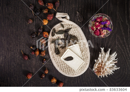 natural soap, dried flowers, sponge and shell on a black background natural soap, dried flowers, sponge and shell on a black background 83633604