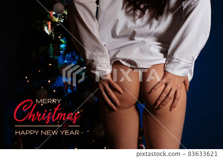 Sexy ass of a girl in underwear at the Christmas tree for the new year 83633621