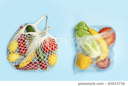 A reusable shopping string bag with vegetables and fruit from the supermarket. Single-use plastic bag ban concept. Zero waste background. High quality photo 83633736