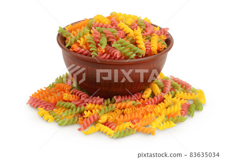 raw Fusilli in ceramic bowl colored pasta, isolated on white background with clipping path and full depth of field 83635034